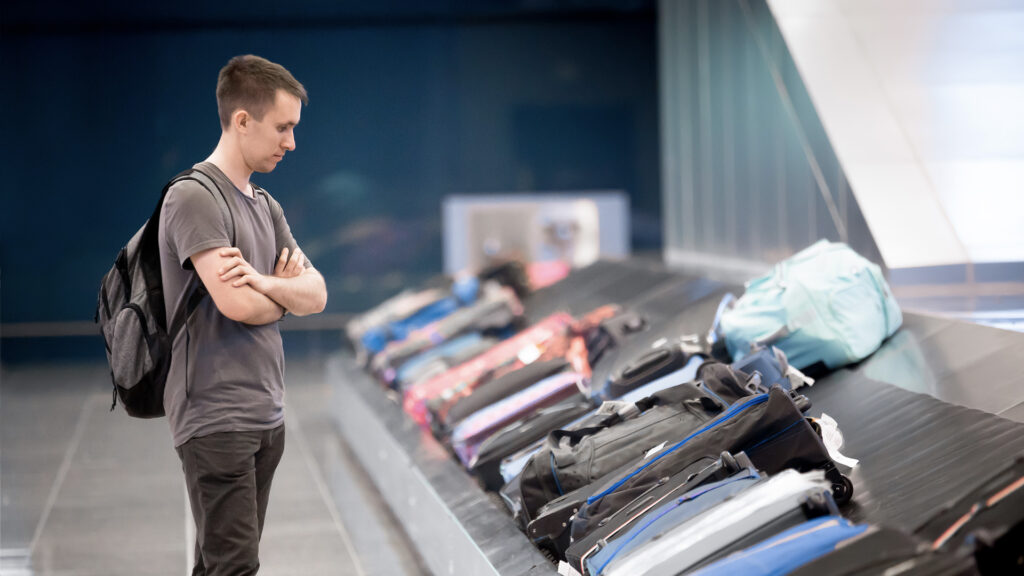 A person waiting for his luggage bag